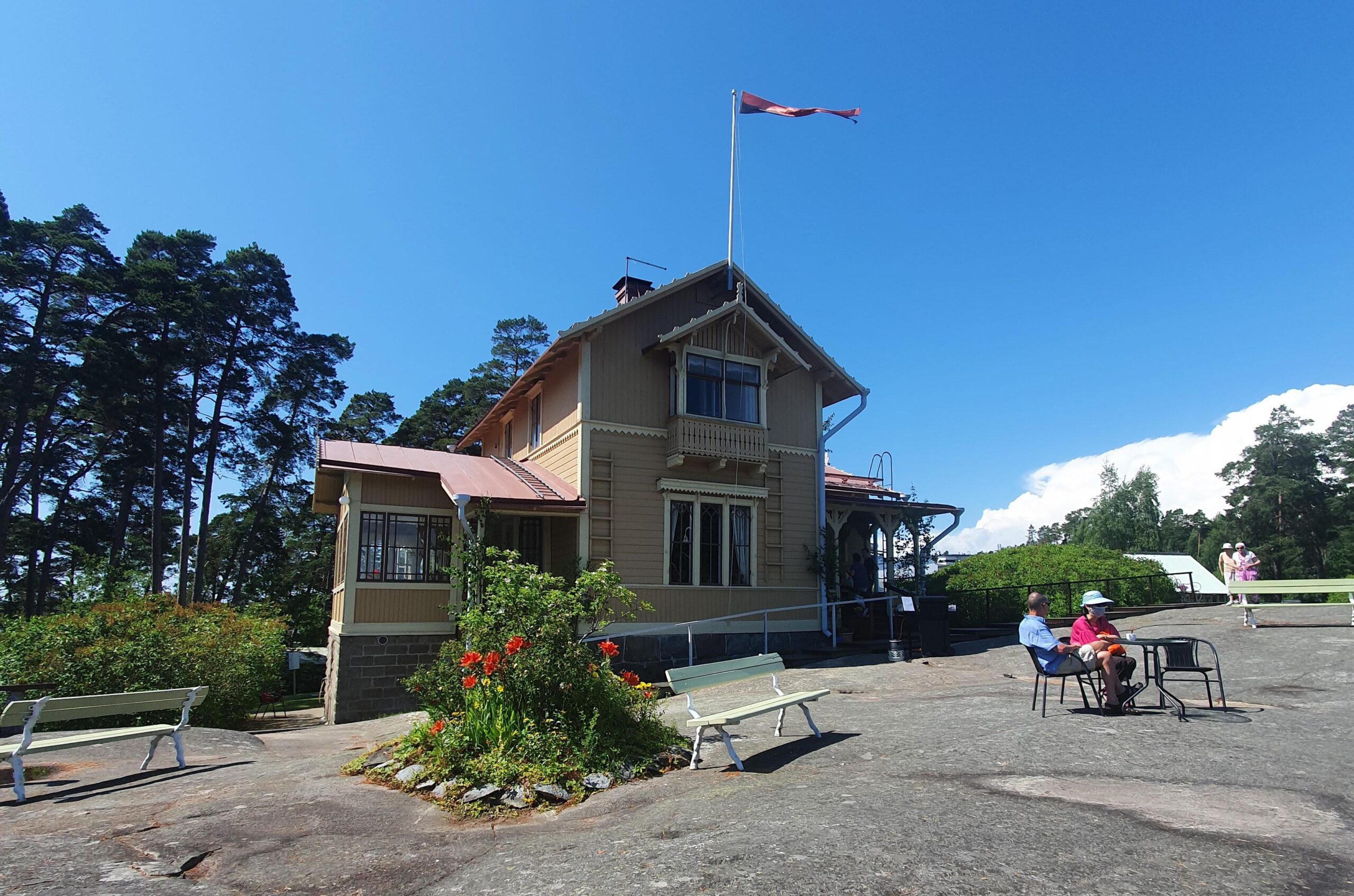Villa Salmela in Jollas district, people sitting outside the building.