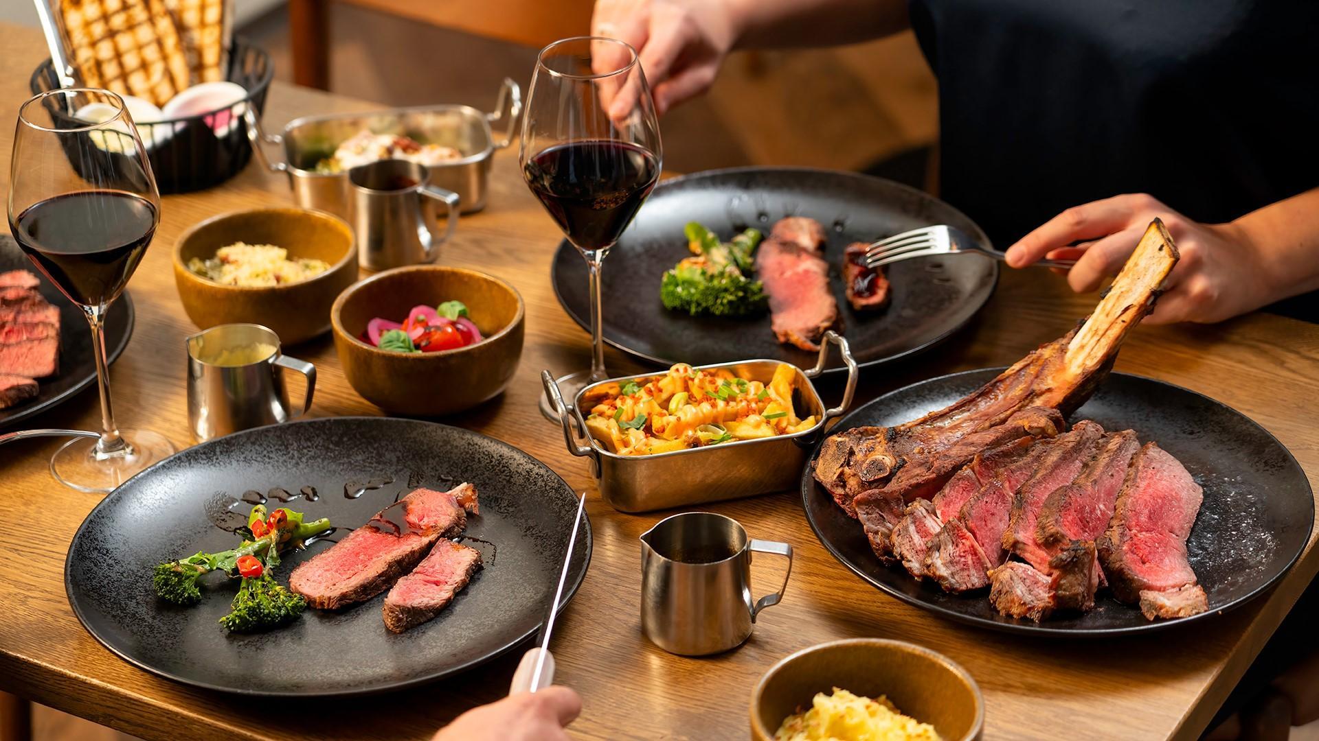 Grill it! Tapiola Garden. On the photo, there's a table with dishes and beverages.