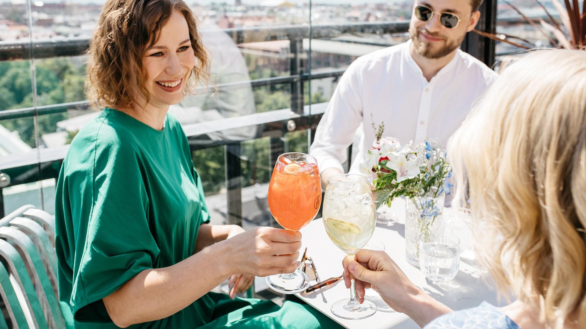 Ateljee Bar, on the photo there are people with drinks in their hands.