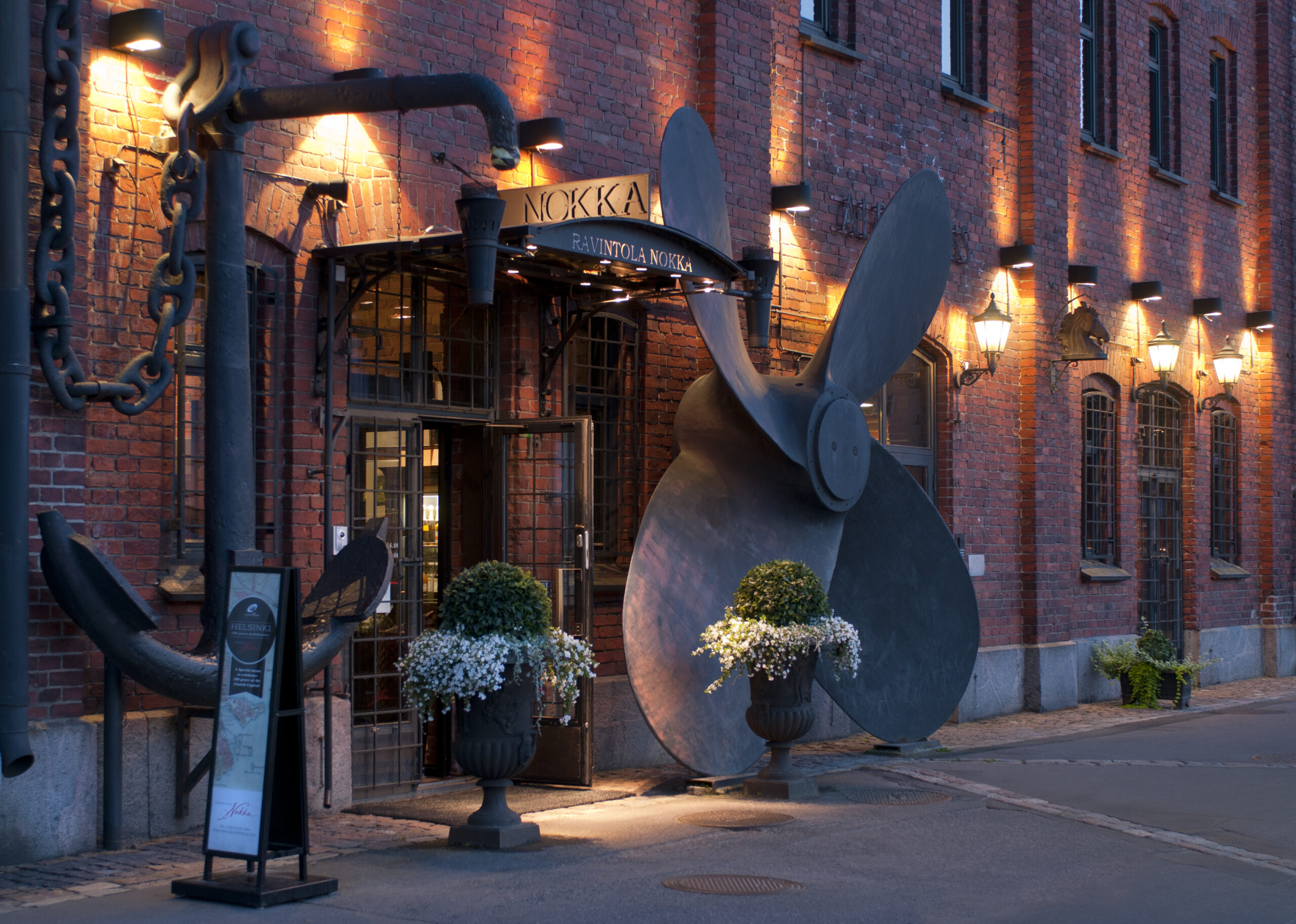 a large metal propeller on a brick building