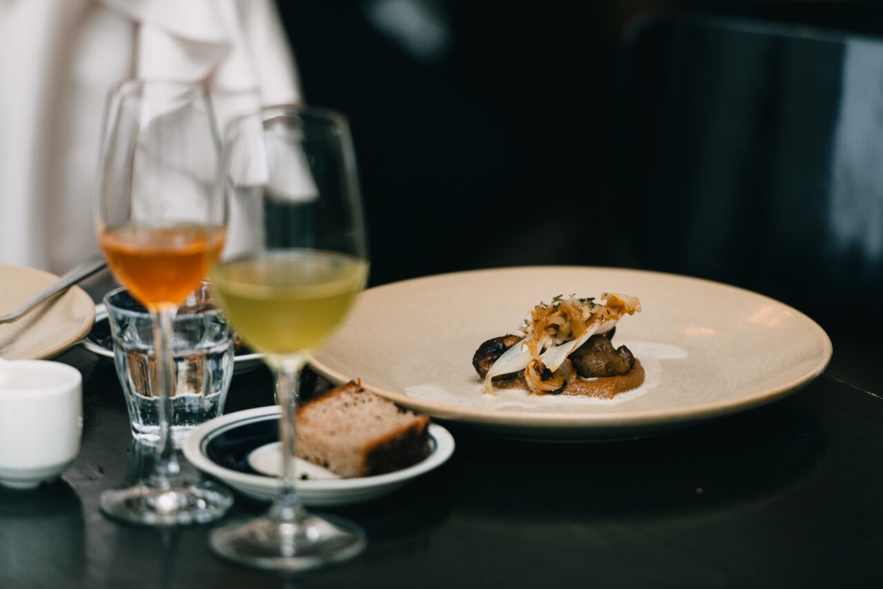 a plate of food and wine glasses