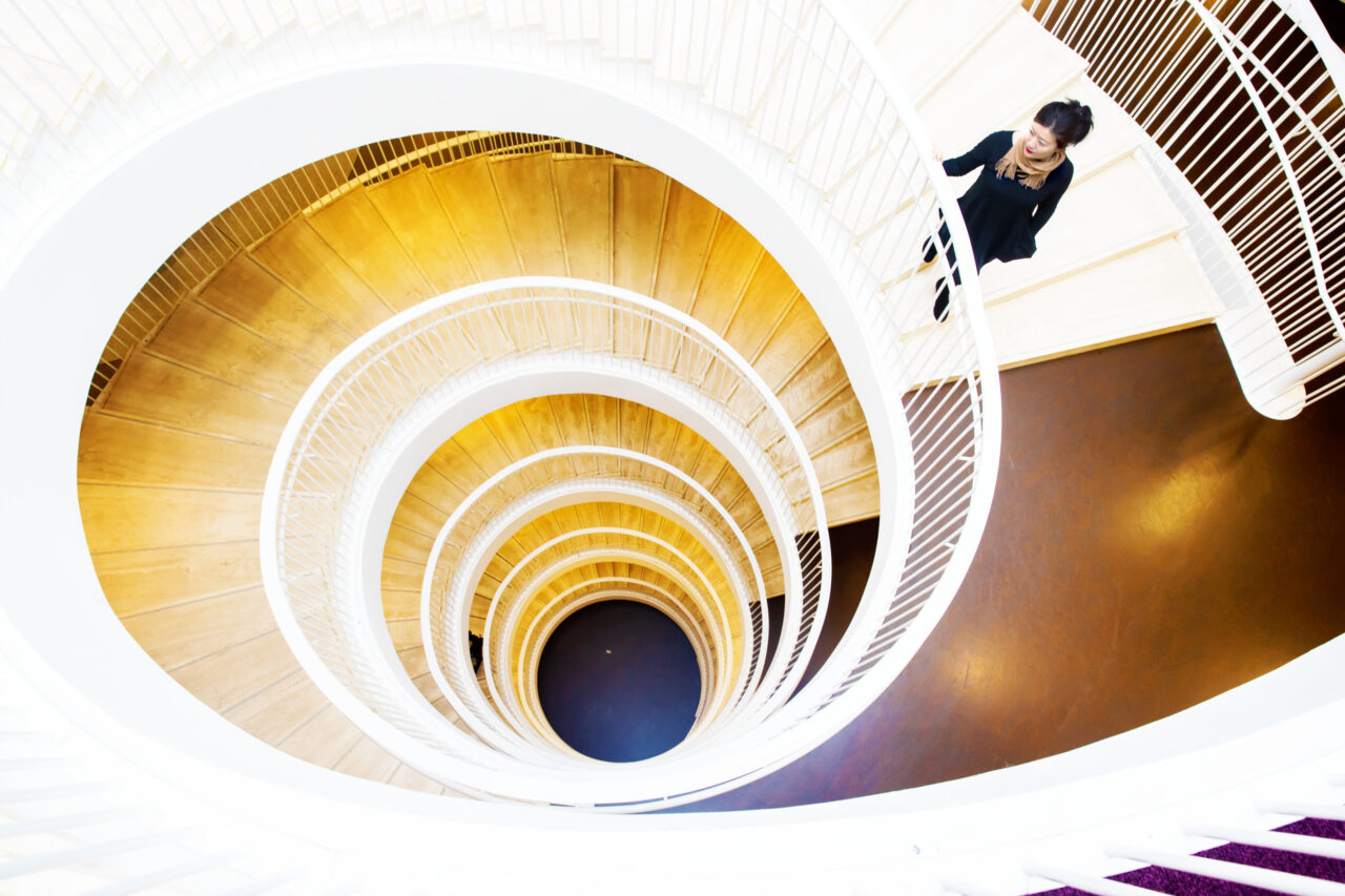 Woman walking down a staircase in Kaisa Library Helsinki