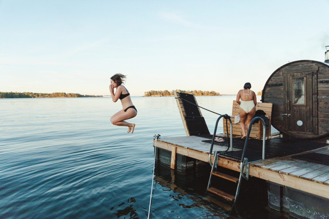 Girl jumping to the sea in Helsinki