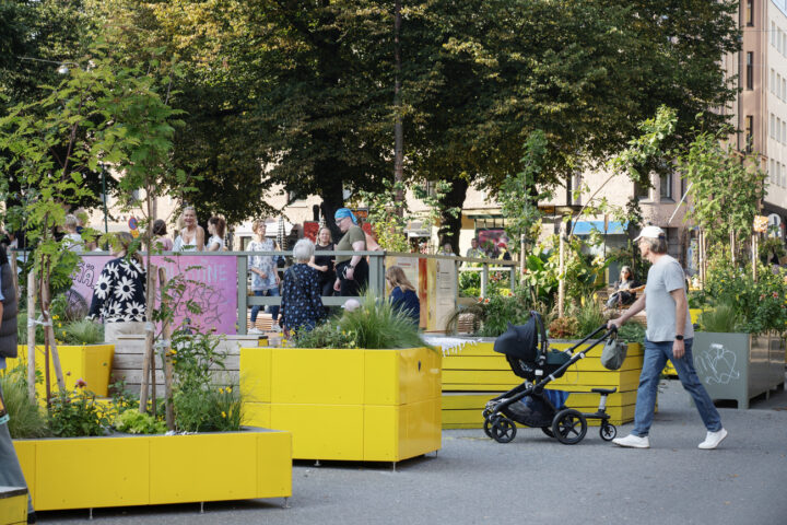 People on the summer streets of Kallio neighbourhood in Helsinki.