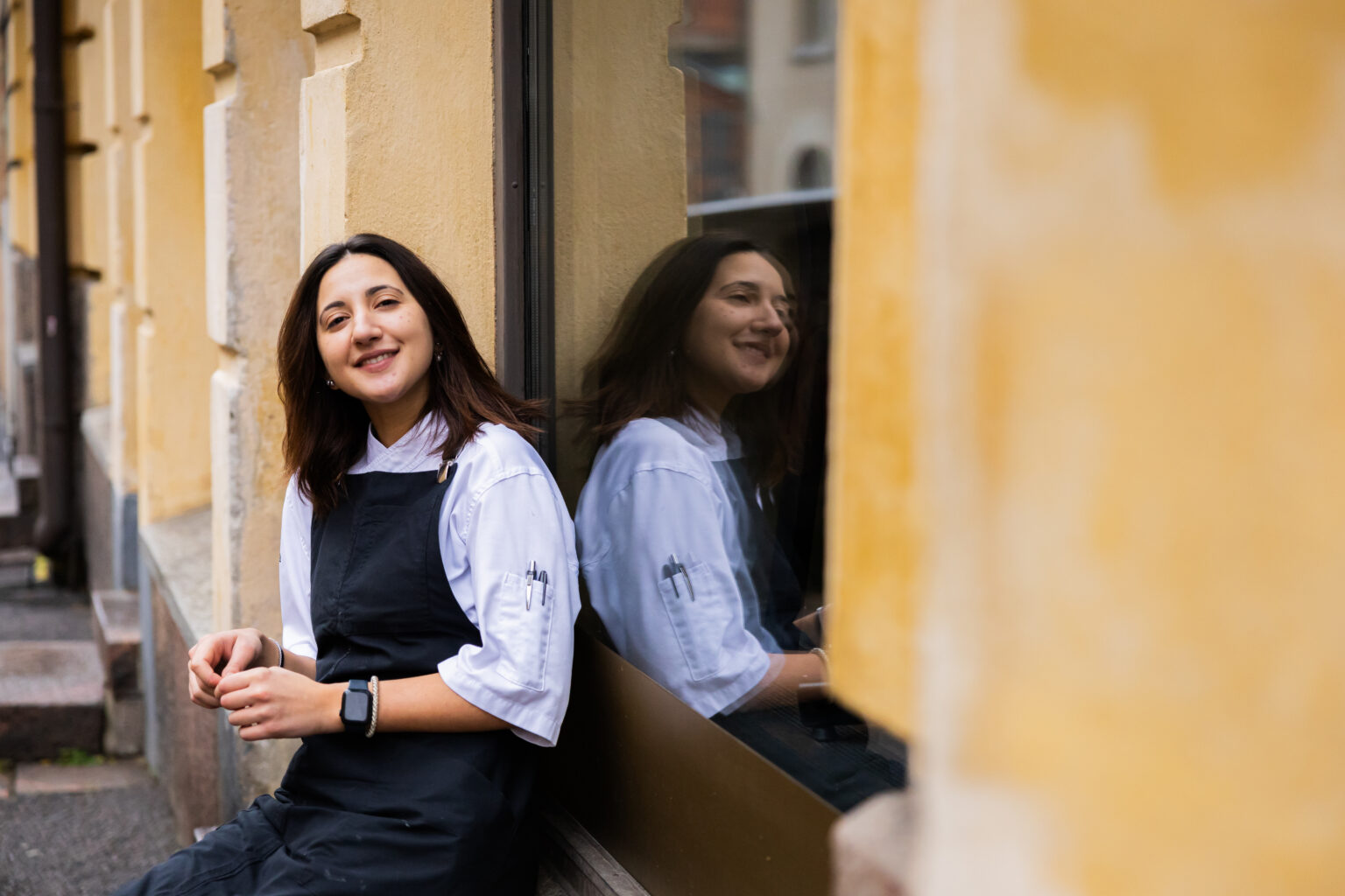 a woman leaning against a window