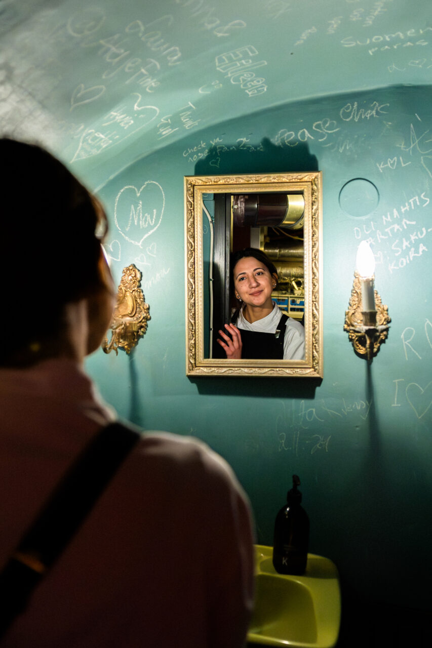 a woman looking at a mirror
