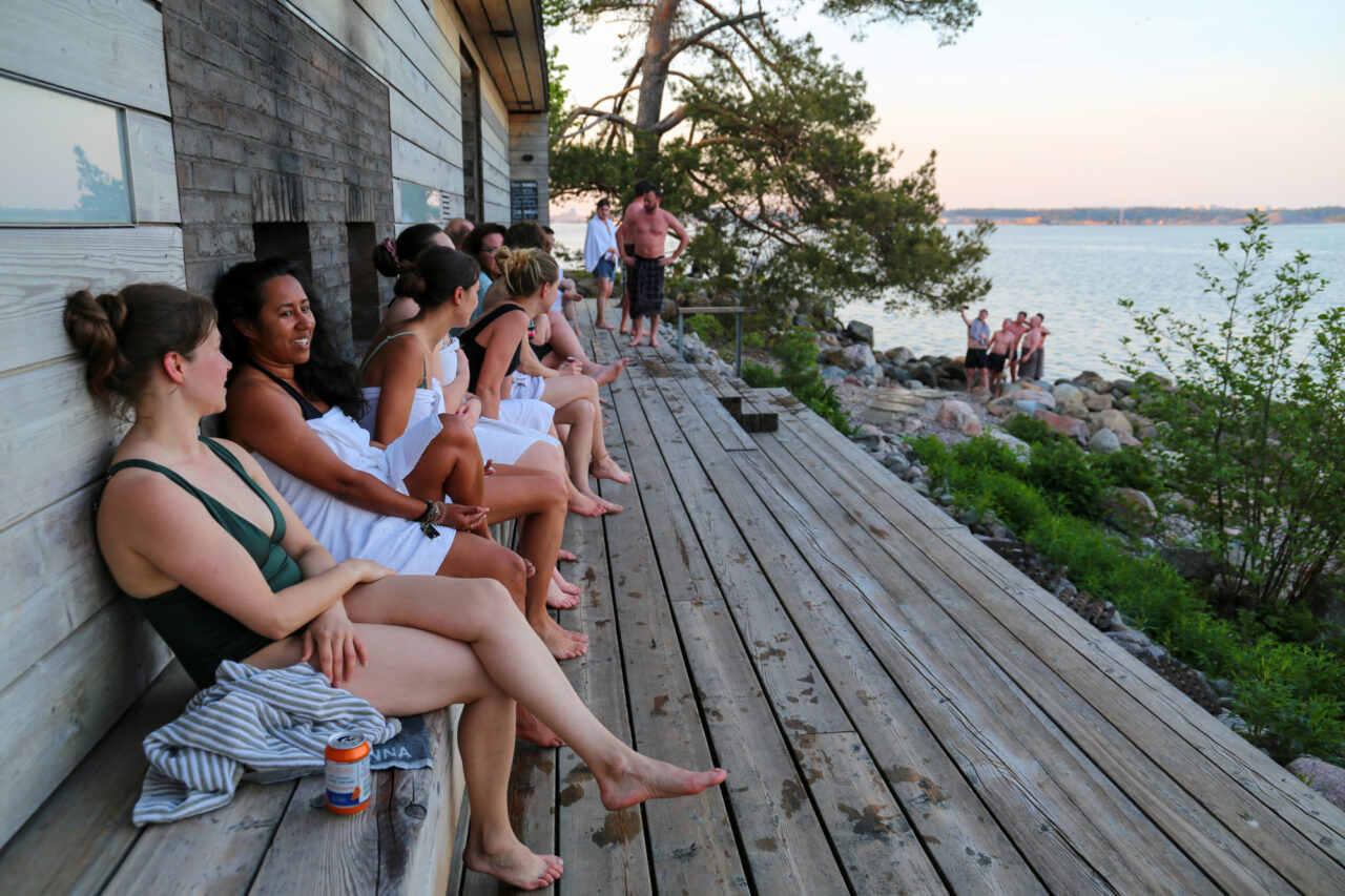 People sitting in front of Lonna island sauna