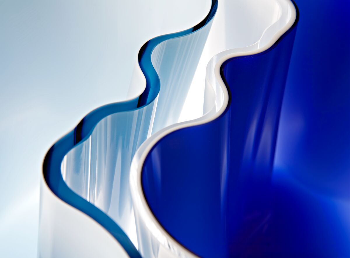 a close up of a blue and white glass from Aalto