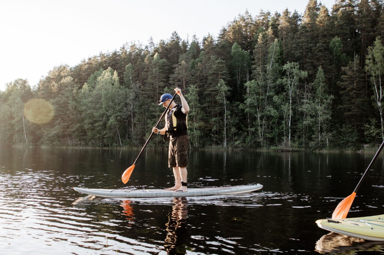 A man on a paddle board on a Nuuksio lake.