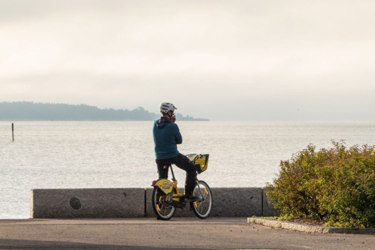 A man on a bicycle by the sea in Espoo.
