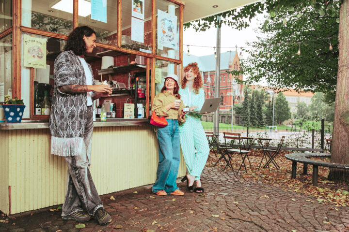 People enjoying drinks outside café.
