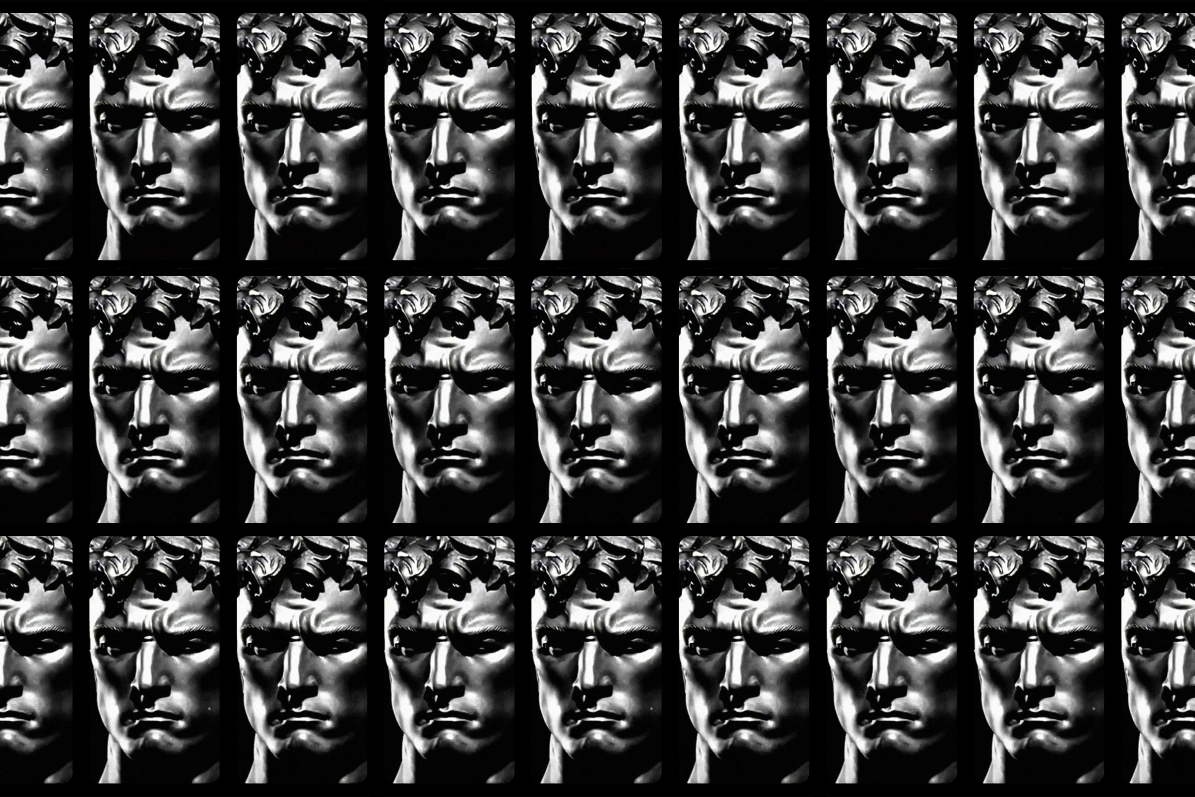 Patsaan mustavalkoiset kasvot monta kertaa riveittäin