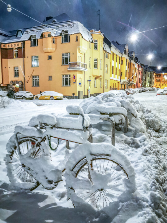 Bikes covered in snow in Huvilakatu street in Helsinki