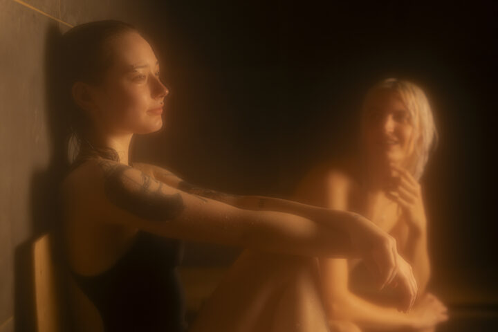 Young woman and man smiling in a warm sauna in Helsinki.