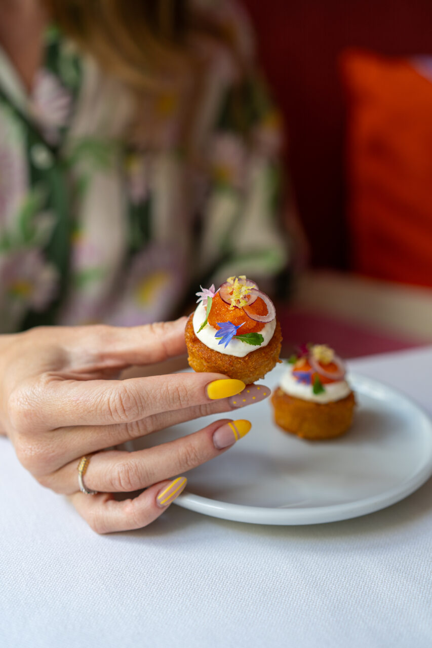 Hand holding decorative gourmet canapé.