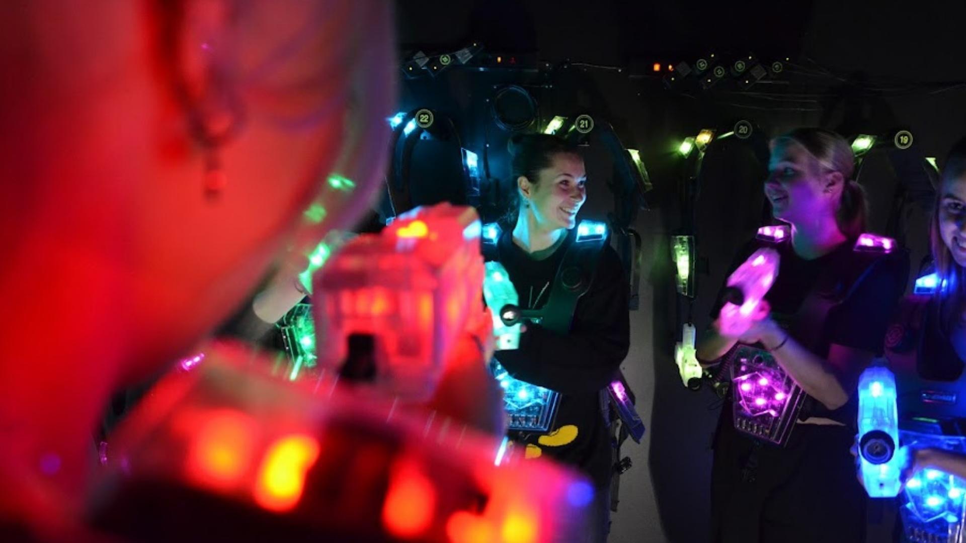 En grupp spelare i Laserareenans utrustning, leende och förberedda inför spelet.