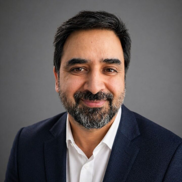 Man with beard in navy suit and white shirt