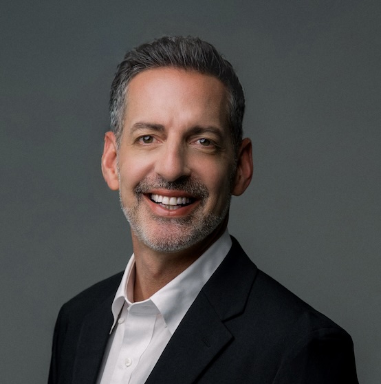 Business professional smiling in a black suit