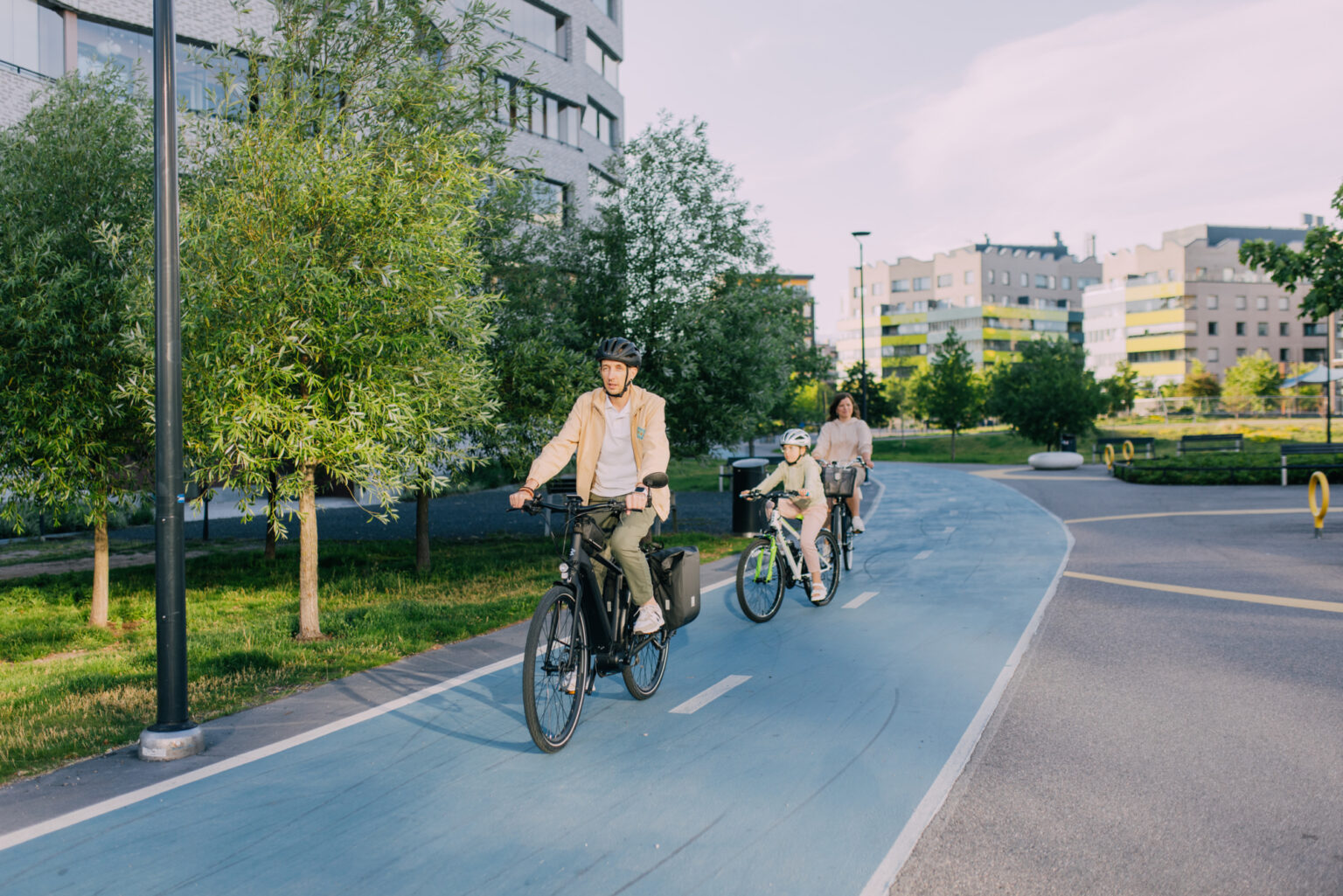 Family cycling on a dedicated bike path in a modern urban park