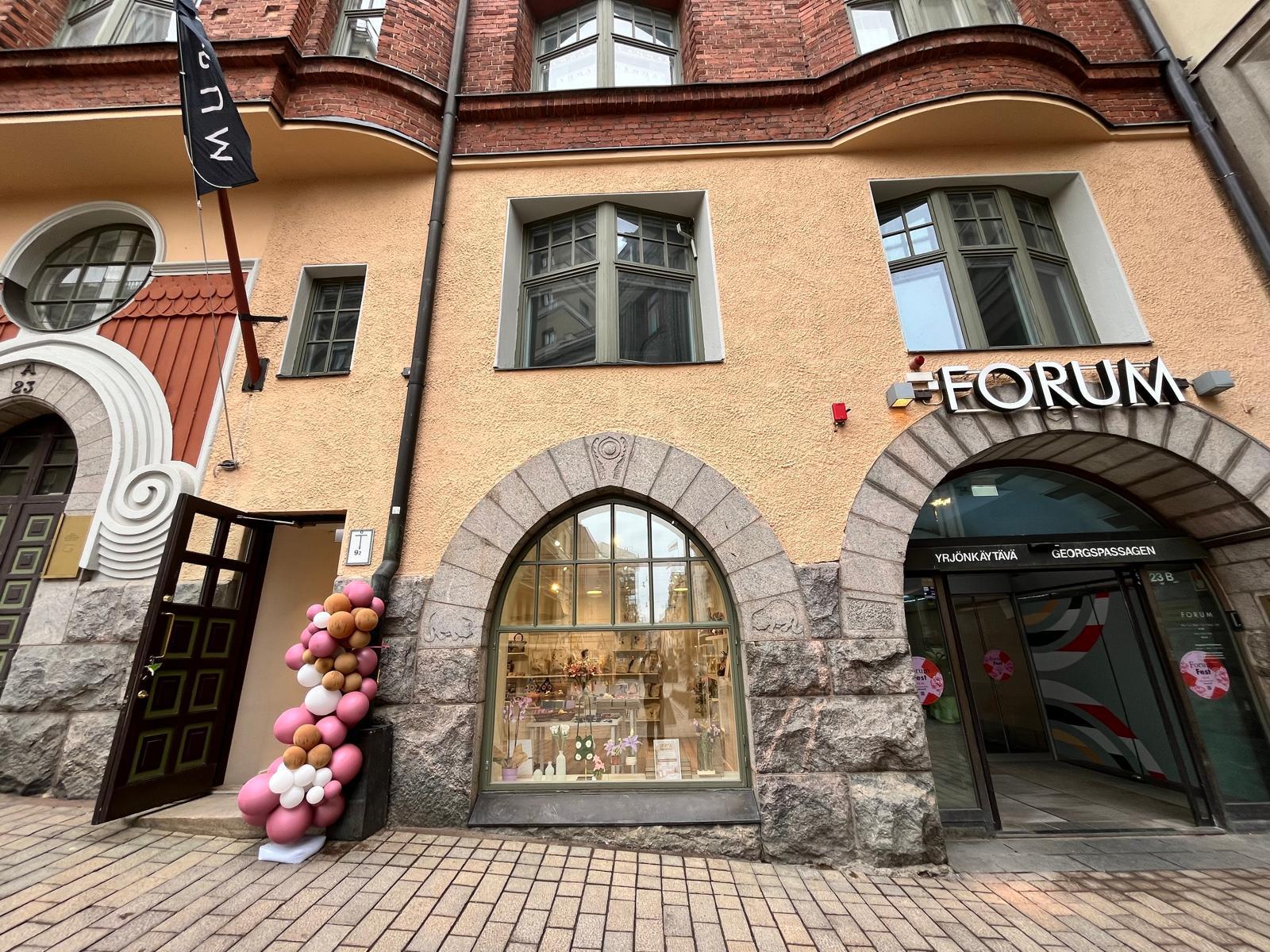The store viewed from the outside. The image shows the store’s door and windows.