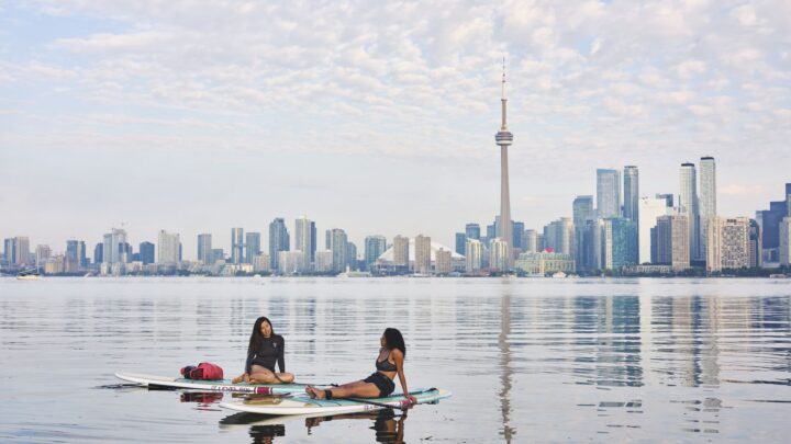 Two women paddleboarding in Toronto