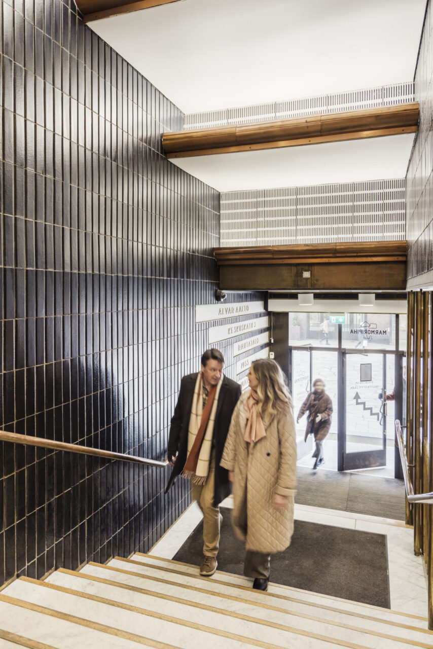 A couple ascending the stairs of Rautatalo in Helsinki.